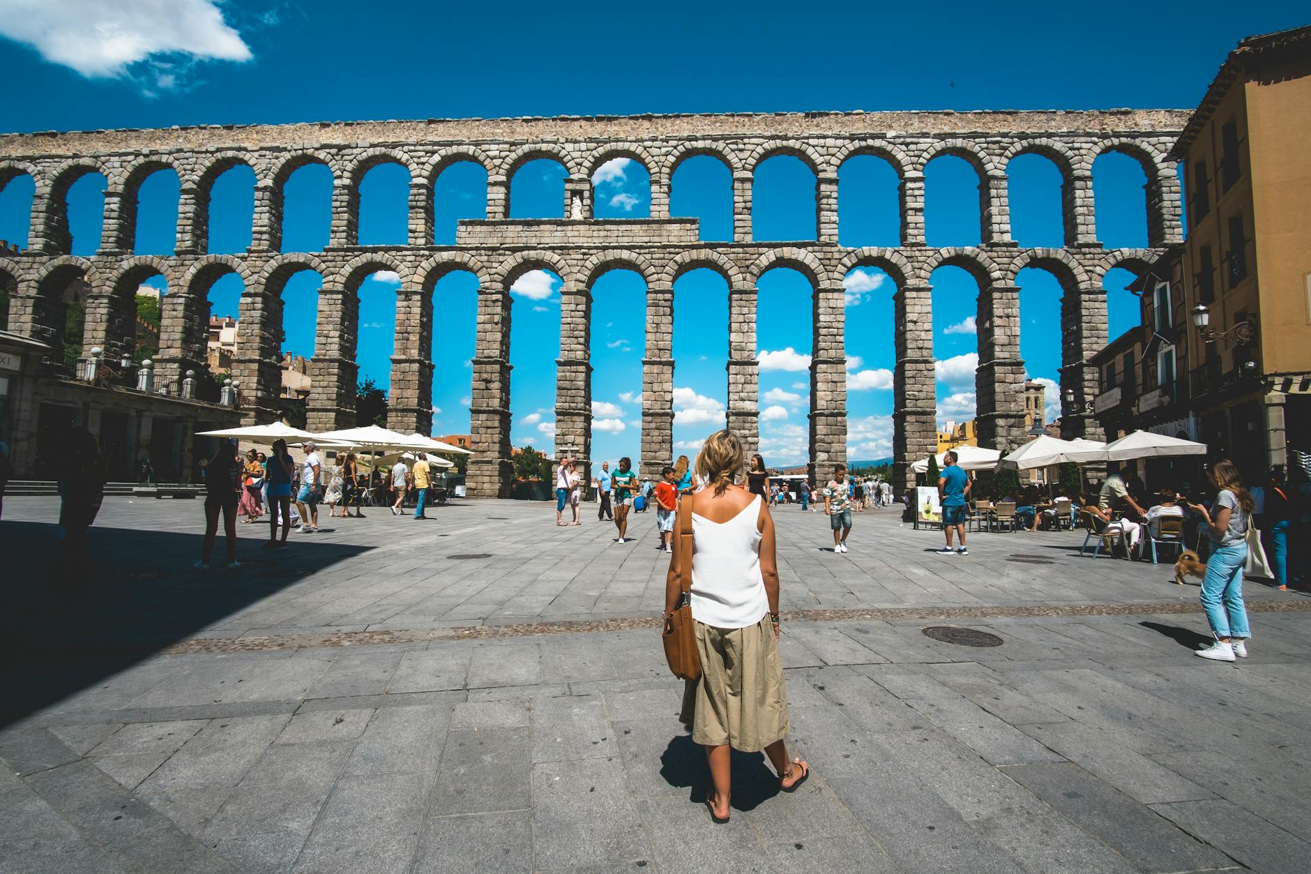 tourists visits the aqueduct in segovia spain
